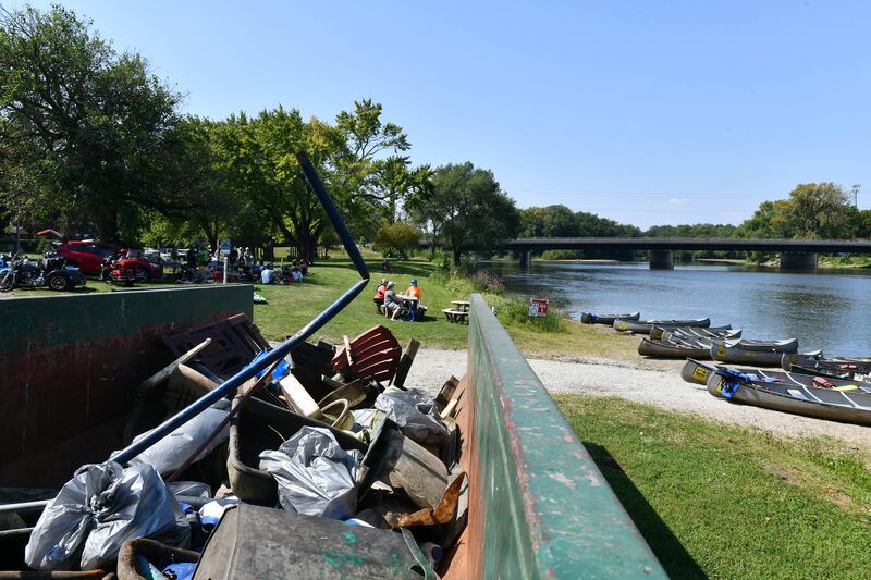 Forty volunteers from Olivet Nazarene University break for lunch in the shade after participating in the 39th Annual Kankakee and Iroquois River Cleanup in 2021.