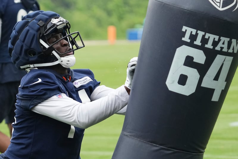 Chicago Bears wide receiver Olamide Zaccheaus hits a blocking dummy during NFL football practice at Halas Hall in Lake Forest, Ill., Wednesday, June 4, 2025. (AP Photo/Nam Y. Huh)