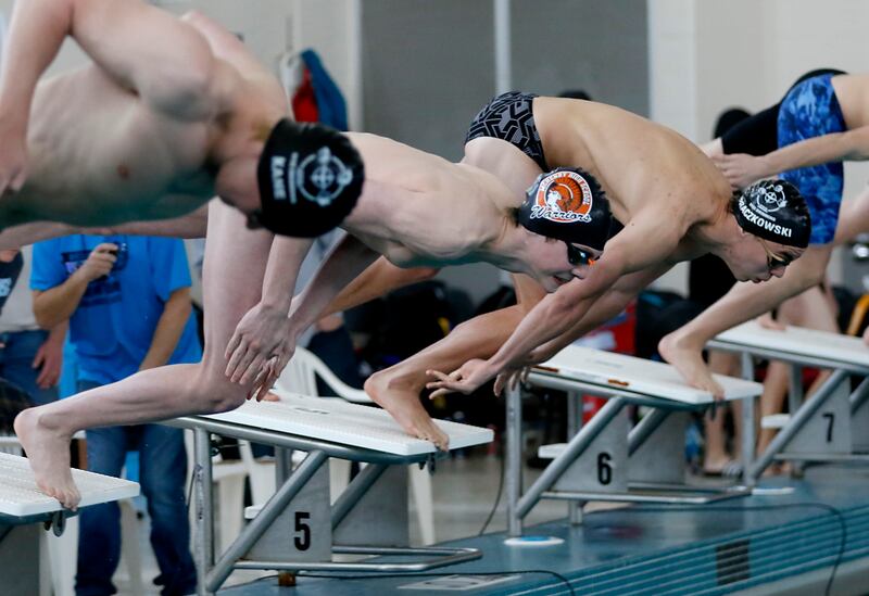 McHenry’s Robbie Rosenbaum dives into the pool as he competes in the 100 Freestyle during the Fox Valley Conference Invitational swim meet on Saturday, Feb. 15, 2025, at Woodstock North High School.