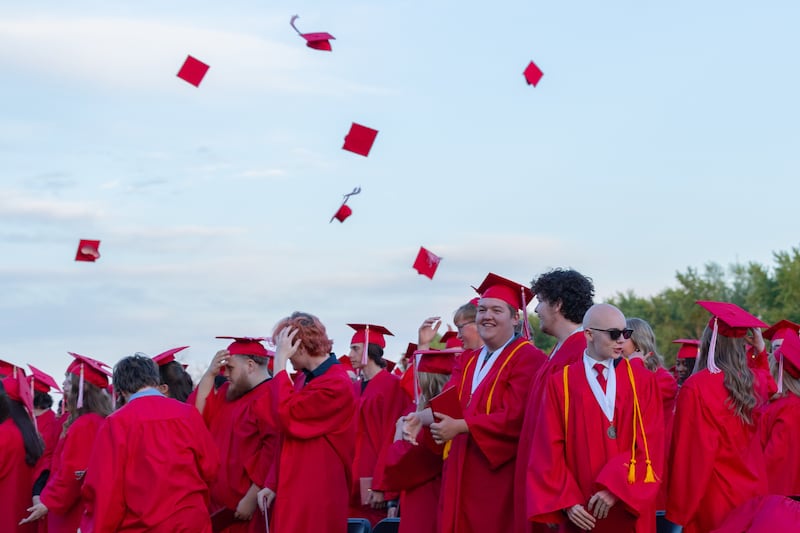 Graduates throw caps into the air on Friday, May 23, 2025, at Ottawa High School in Ottawa.