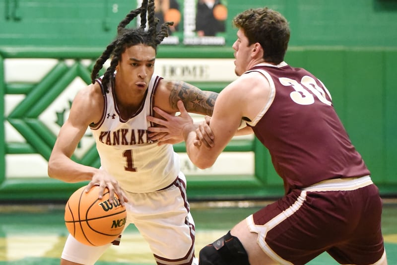 Kankakee's Lincoln Williams, left, drives to the basket as Morris' Cade Laudeman defends during the IHSA Class 3A Geneseo Regional semifinals Wednesday, Feb. 25, 2026.