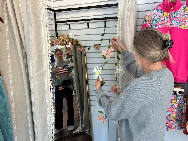 Tawny Haberski adds decor to the changing room at Curated by Laney Boutique on Sunday, April 26, 2026. It is the second year for Haberski at the McHenry Riverwalk Shoppes.