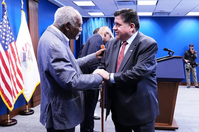 Governor JB Pritzker, right, shakes hands with Rep. Danny Davis, D-Ill., as he leaves after a news conference in Chicago, Monday, Oct. 6, 2025. (AP Photo/Nam Y. Huh)