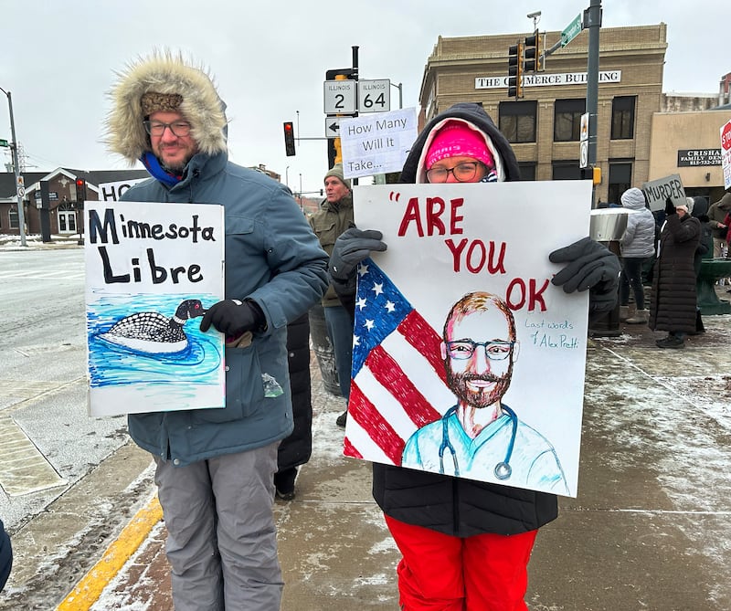 Two people who attended an Indivisible of Ogle County's protest in downtown Oregon on Sunday, Jan. 25, 2026, hold signs referring to the shooting death of Alex Pretti by ICE agents on Saturday in Minneapolis.