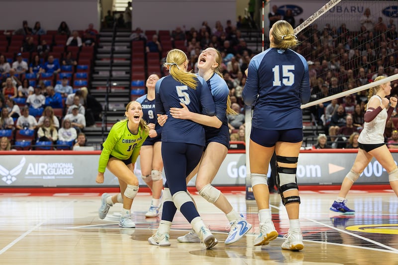 Cissna Park's Sophie Duis hugs Mady Marcott (5) as the team celebrates during the Timberwolves' victory in two sets, 25-19, 25-20, over Tremont in the IHSA Class 1A State semifinals on Friday, Nov. 14, 2025.