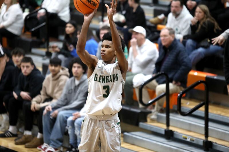 Glenbard West's TJ Williams shoots three points during a Class 4A St. Charles East Sectional semifinal against Glenbard East on Tuesday, March 4, 2025 in St. Charles.