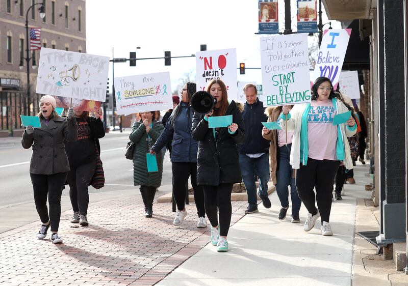 Marchers head east on Lincoln Highway Monday, April 7, 2025, during the Safe Passage Take Back the Night and Survivor Speak Out in Dekalb. The event is held in conjunction with Sexual Assault Awareness Month.