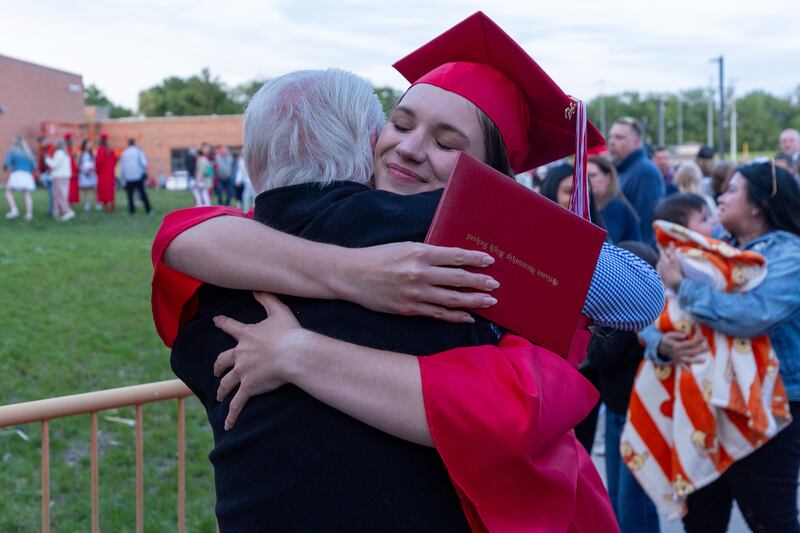Lee Niedzwecki hugs graduate Ansley Leonard on Friday, May 23, 2025, at Ottawa High School in Ottawa.