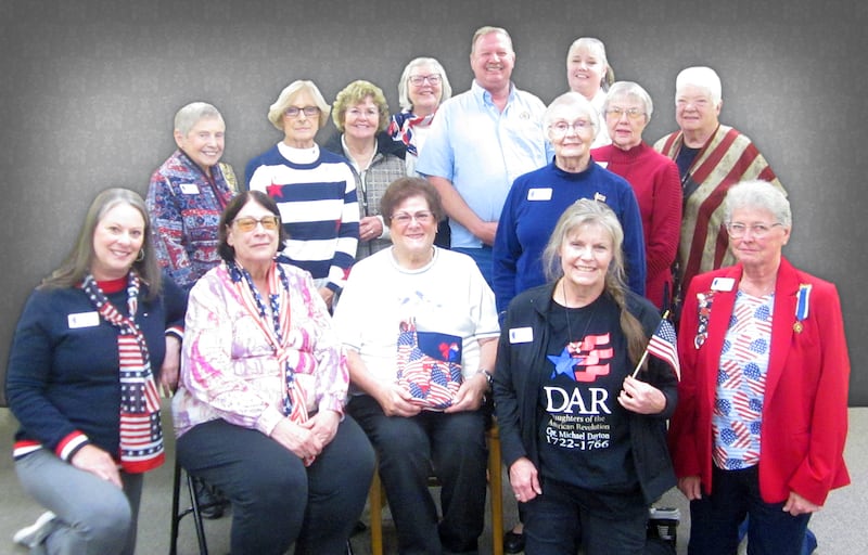 Members of the Chief Senachwine Chapter, Daughters of the American Revolution, surround program presenter, Roger Masters, Commander of Henry's American Legion Post 323, who shared his military experiences with the group.