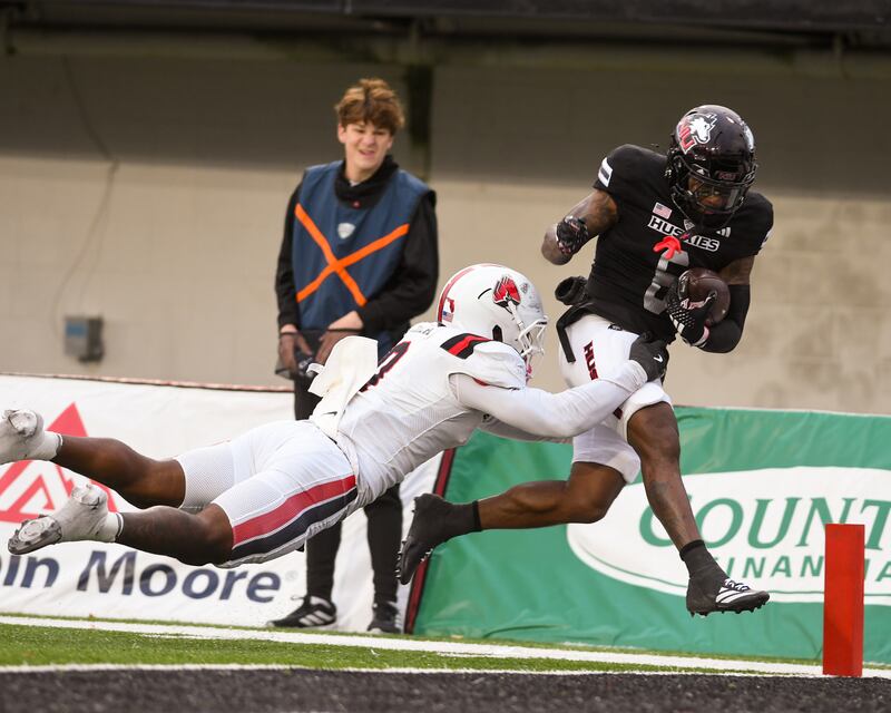 Northern Illinois University's wide receiver DeAree Rogers (6) scores a touchdown while being defended by Ball State’s defender Alfred Chea (0) during the game on Saturday Oct. 25, 2025, held at Huskie Stadium in DeKalb.