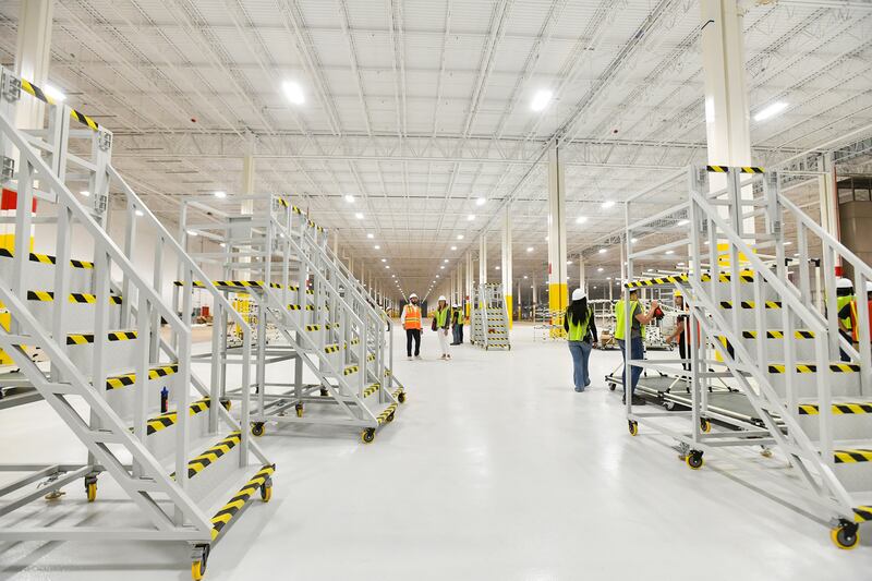 Gotion workers prepare an assembly line for filling temperature-controlled battery storage containers with batteries at the Manteno site in October 2024.