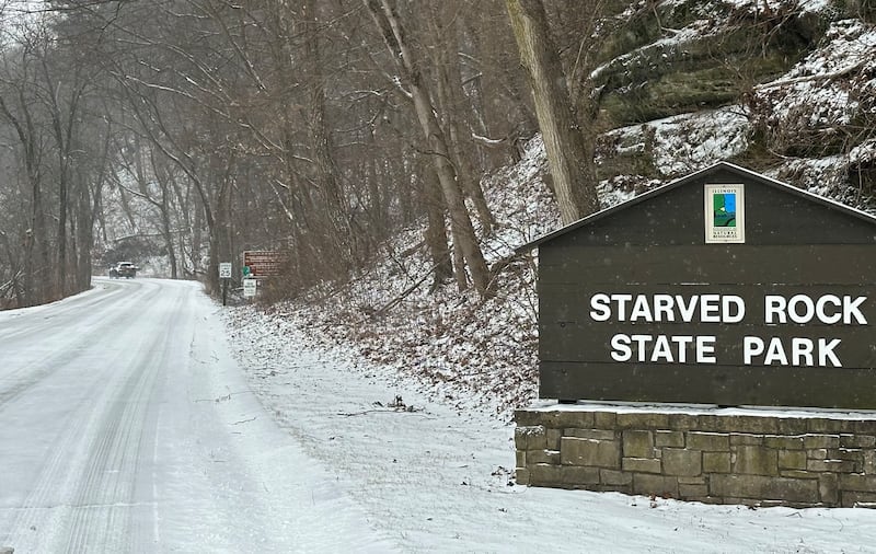 A motorist enters Starved Rock State Park as snow covers the main entrance roadway on Wednesday, Feb. 12, 2025 near Utica.