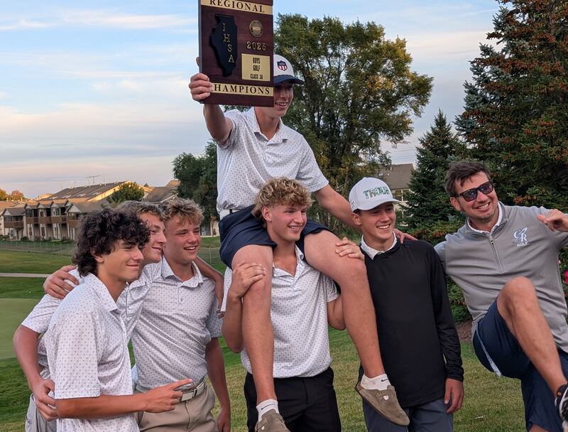 Burlington Central's Tyler Samaan holds the championship plaque aloft while sitting on the shoulders of teammate Devin Hughes after the Rockets won the Class 3A Huntley Boys Golf Regional on Wednesday, Oct. 1, 2025, at Pinecrest Golf Club in Huntley. Also pictured (from left) are Colin Gritzman, Evan Sarallo, Matthew Zierk, Tommy Wyse (standing next to Hughes) and head coach Thomas Davies.
