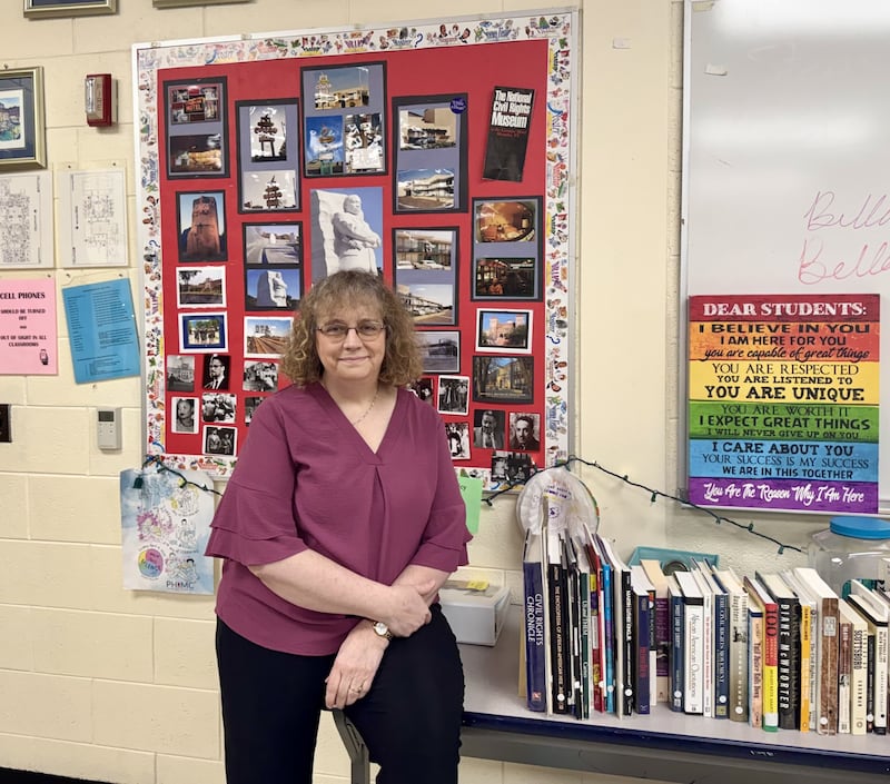 Marilee Applebee stands in front of her classroom bulletin board, which displays challenged books as part of her curriculum on censorship and intellectual freedom. Applebee, who is retiring after 34 years at Seneca High School, uses the bulletin boards to open each unit and engage students in discussions about why certain books have been challenged.
