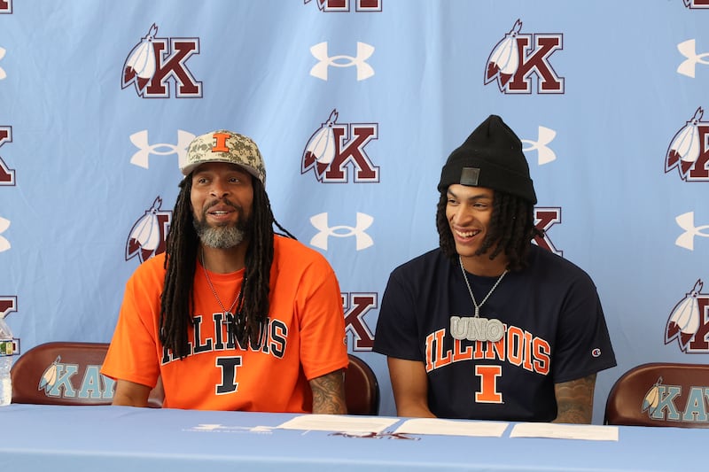 Lincoln Williams prepares to sign his commitment papers alongside his father, Sammy, left, to play basketball at University of Illinois on Monday, June 8, 2026, at Kankakee High School.