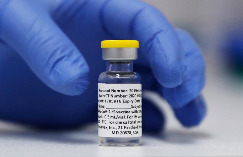 FILE - A vial of the Phase 3 Novavax coronavirus vaccine prepared for use in a trial at St. George's University hospital in London, Oct. 7, 2020. (AP Photo/Alastair Grant, File)