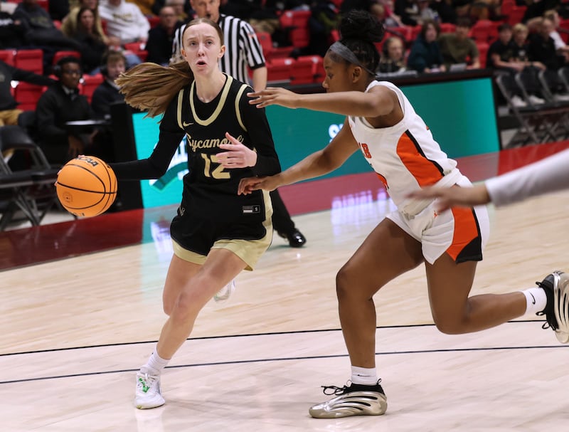 Sycamore's Sadie Lang drives against DeKalb's Johnna Patrick Friday, Jan. 30, 2026, during their game in the FNBO Challenge in the Convocation Center at Northern Illinois University in DeKalb.