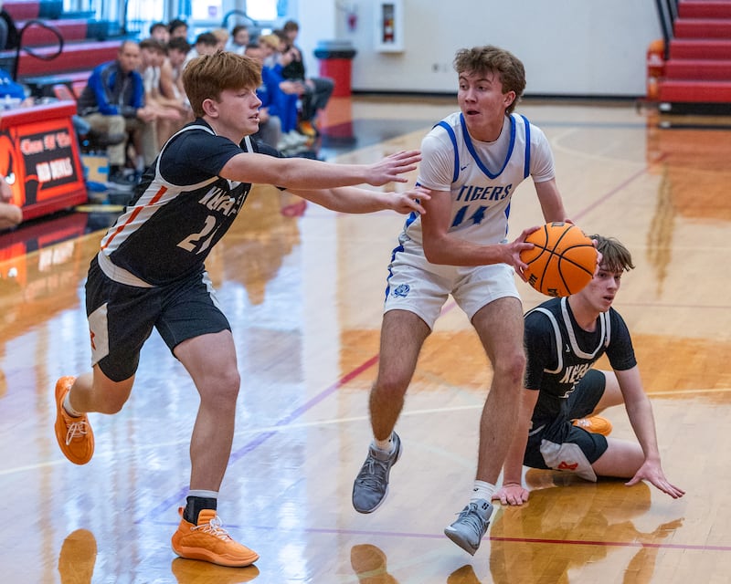 Jackson Mason (14) of Princeton drives ball in lane as Leeam Slover (21) of Kewanee guards during the Colmone Classic on Saturday, December 13, 2025 at Hall High School in Spring Valley.