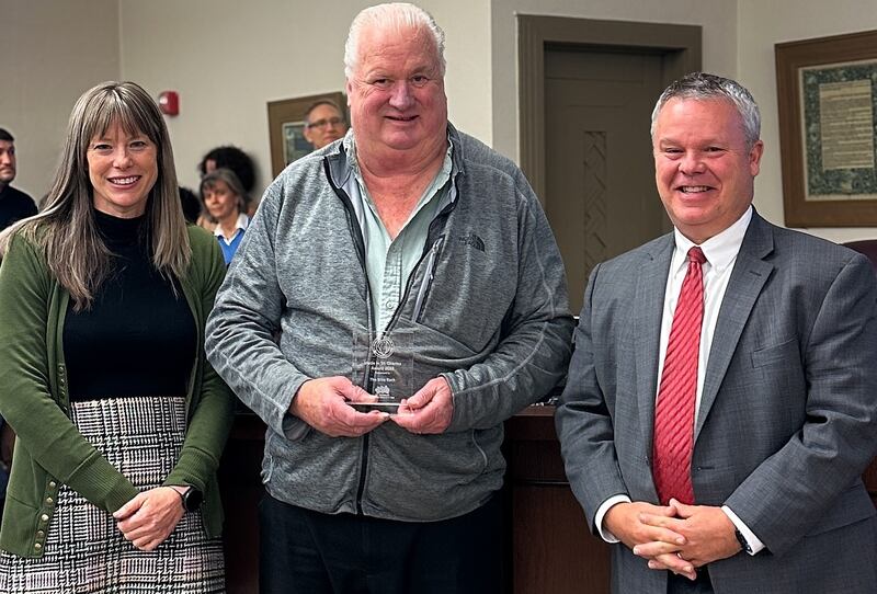 The Bike Rack received a 'Made in St. Charles Award' on Nov. 17, 2025. Pictured, Executive director of the St. Charles Business Alliance Jenna Sawicki, The Bike Rack Owner Hal Honeyman,  and Mayor Clint Hull.