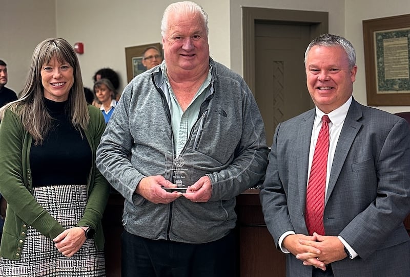 The Bike Rack received a 'Made in St. Charles Award' on Nov. 17, 2025. Pictured, Executive director of the St. Charles Business Alliance Jenna Sawicki, The Bike Rack Owner Hal Honeyman, and Mayor Clint Hull.