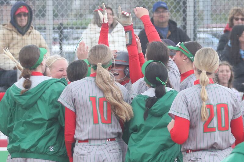 Members of the L-P softball team rush to the plate to congratulate teammate Karmen Piano on hitting a solo home run against Ottawa on Monday, April 21, 2025 at the L-P Athletic Complex in La Salle.