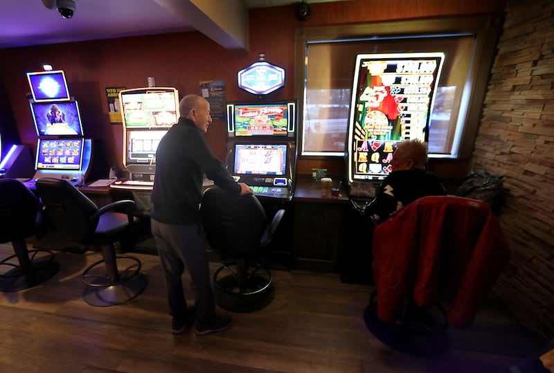 Kim Alimi the owner of 3 Brothers Restaurant  talks with a customer as she plays a video gaming machine inside the Woodstock restaurant on Thursday, Jan. 22, 2026. Woodstock is considering additional regulations surrounding video gaming in the city.