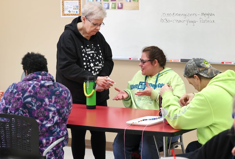 Marilyn Bell, a long-time direct support professional at Opportunity House, works with clients Thursday, Nov. 2, 2023, at the facility in Sycamore. Opportunity House will be celebrating its 60th anniversary Thursday, Nov. 9 at Faranda's Banquets in DeKalb.