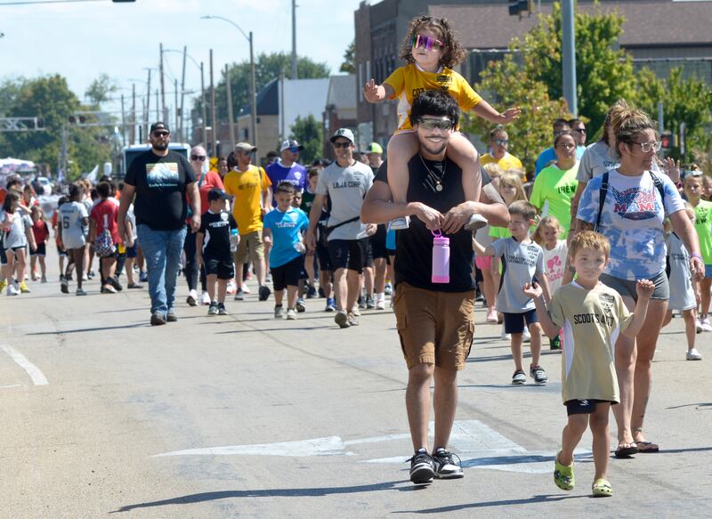 Players and parents of the Streator Youth Soccer League march down Main St. Sunday during the Chamber of Commerce Labor Day Parade in Streator.