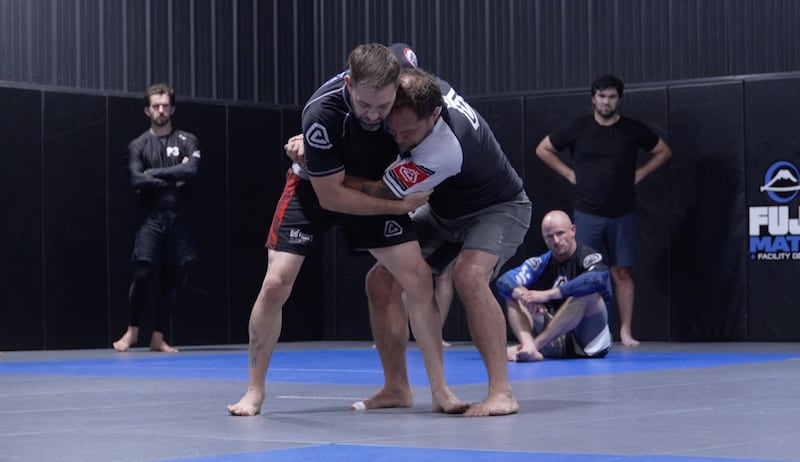 Jeff Curran (right) demonstrates a takedown on Justin Seeberger during a group class at Team Curran in Crystal Lake as Curran prepares Seeberger for his upcoming match at the inaugural Jeff Curran Invitational.