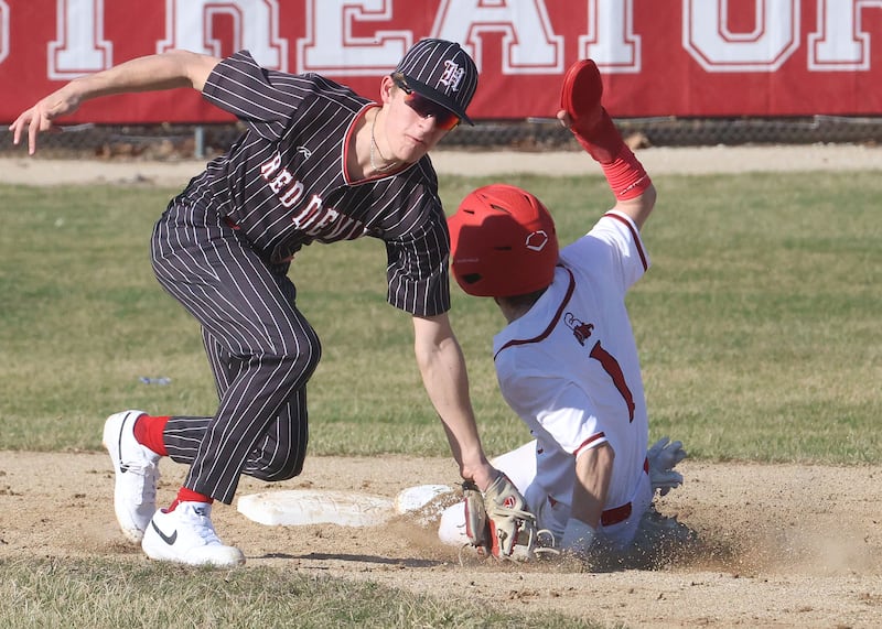 Hall's Luke Bryant misses the tag on Streator's Keegan Angelico on Thursday, March 19, 2026 at Streator High School.