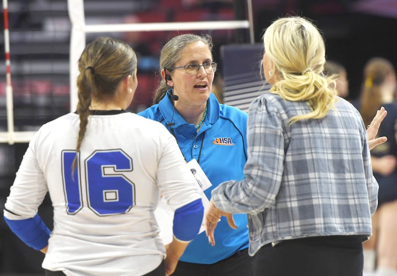 Robin Keene of Mt. Morris speaks with Columbia coach Kelly Landgraf and player Ella Horner in the 2A semifinals of the state volleyball tournament at Illinois State University on Friday and Saturday, Nov. 14, 2025.