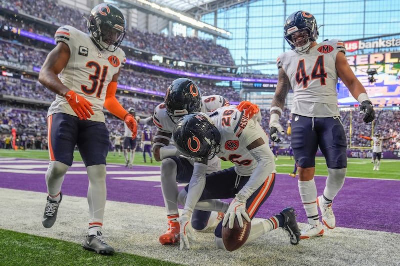 Chicago Bears cornerback Nahshon Wright (26), center, celebrates after an interception during the first half of an NFL football game against the Minnesota Vikings, Sunday, Nov. 16, 2025, in Minneapolis. (AP Photo/Abbie Parr)