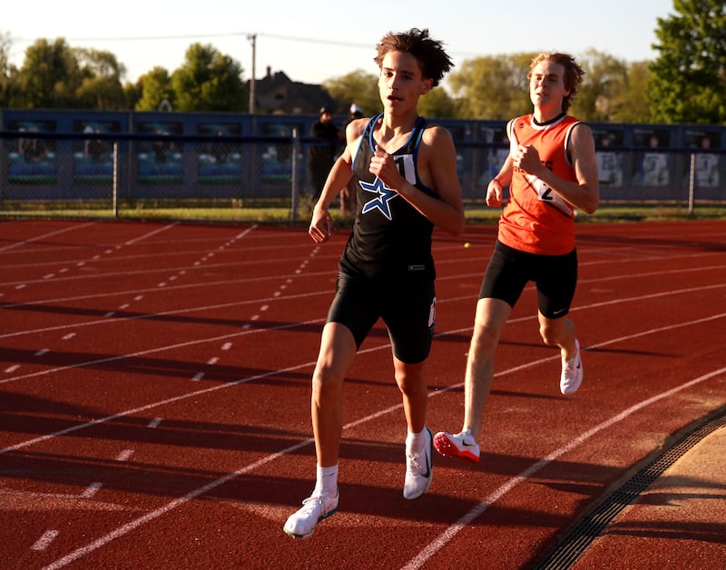 St. Charles North’s Samuel Hill and Kaneland’s Evan Nosek compete in the 3200-meter run during the Kane County boys track and field championships on Friday, May 9, 2025 at St. Charles North.