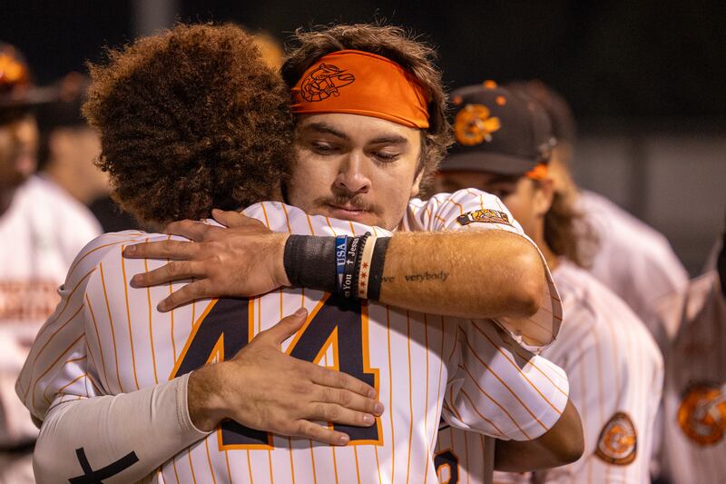(left to right) D’Andre Gaines of the Pistol Shrimp is embraced by teammate Pambos Nicoloudes after the final game of the 2025 season on Thursday, July 31, 2025, at Schweickert Stadium in Peru.