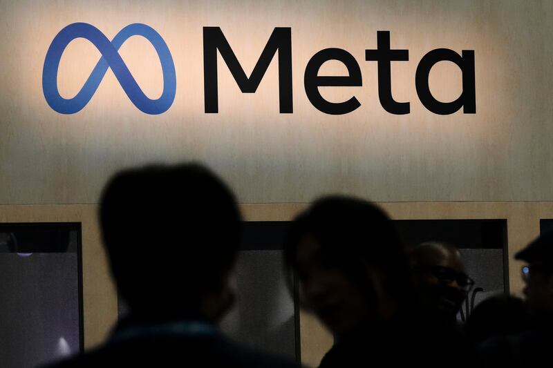 FILE - Attendees visit the Meta booth at the Game Developers Conference 2023 in San Francisco on March 22, 2023. (AP Photo/Jeff Chiu, File)
