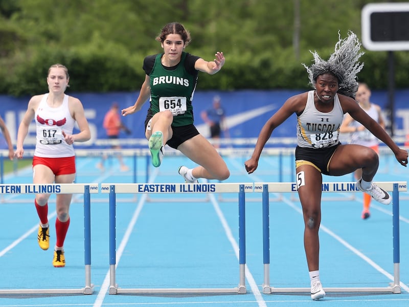 St. Bede’s Lily Bosnich, center, clears the final hurdle just behind Tuscola's Lia Patterson in the 300 m hurdles during the IHSA Class 1A Girls Track & Field State Finals on Saturday, May 24, 2025.