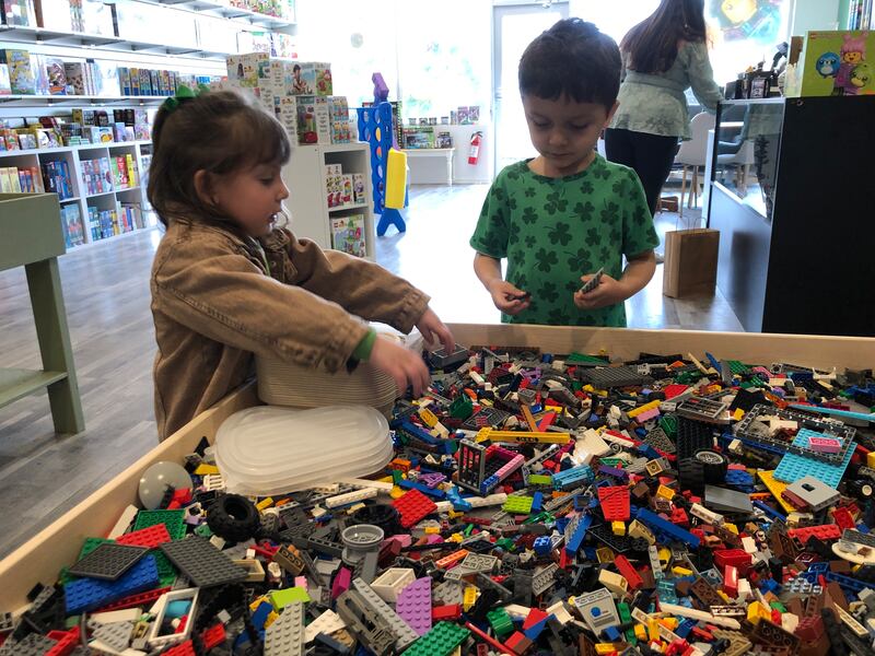 Elenor Springer, 3, and Fallon Speciale, 5, check out the Legos at The Pieceful Project on Saturday, March 15, 2025. The Lego, game and puzzle store on Green Street opened in time to capture the crowds during McHenry's ShamROCKS the Fox festival.