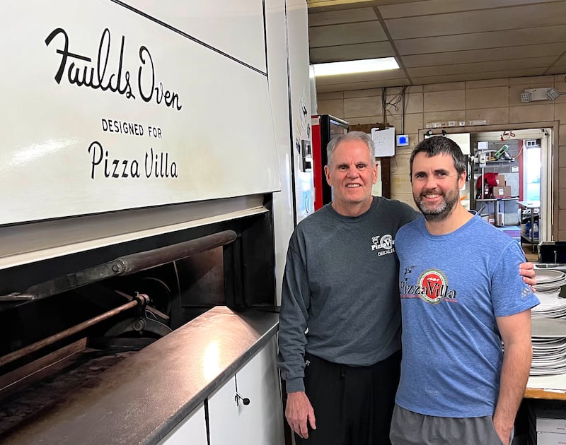 Joe Finn (left) and his son CJ, co-owners of Pizza Villa, by their pizza oven Monday, Jan. 26, 2026, at the restaurant on Lincoln Highway in DeKalb.