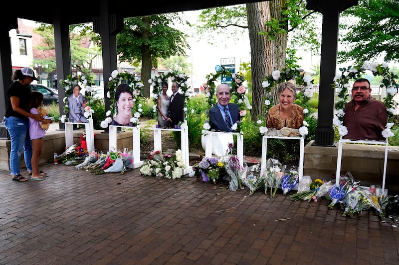 FILE - Visitors pay their respects, Thursday, July 7, 2022, at altars for the seven people killed in the Fourth of July mass shooting in Highland Park. Robert Crimo III, accused of killing seven people and injuring dozens more, including children, at a Fourth of July parade in suburban Chicago in 2022 was scheduled for a court hearing Wednesday, June 26, 2024, when it was possible he would change his not guilty plea, the prosecutor had said. He did not do so.