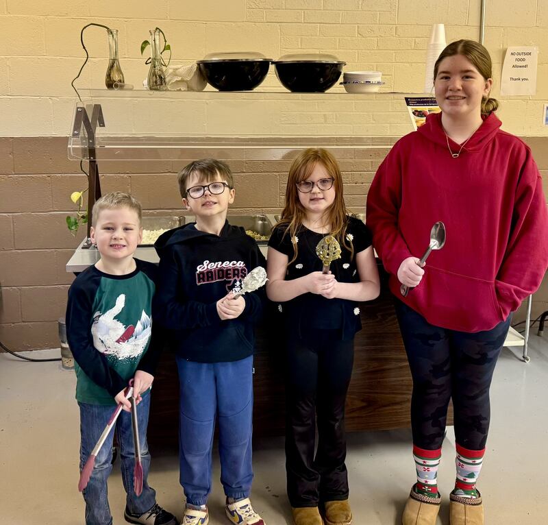 (From left) Will Wilson, Conor Obodzinski, Lucy Obodzinski and Reese Harkins helped serve the meal on Tuesday.