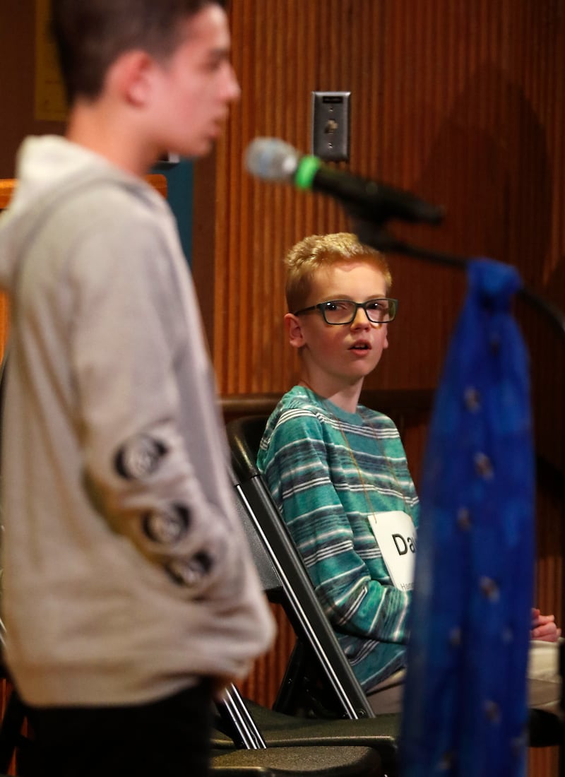 David Koll, of Hannah Beardsley School, watches as Lucas Fiedorowicz of Bernotas Middle School, spells a word during the McHenry County Regional Office of Education 2024 Spelling Bee Wednesday, March 20, 2024, at McHenry County College's Luecht Auditorium in Crystal Lake.
