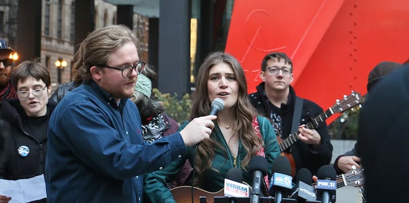 Joselyn Walson, one of six people charged by federal prosecutors in connection to a September 2025 protest in Broadview, sings outside the Dirksen Federal Courthouse in Chicago in November. Conspiracy charges against her and another defendant were officially dropped on Friday, March 13.