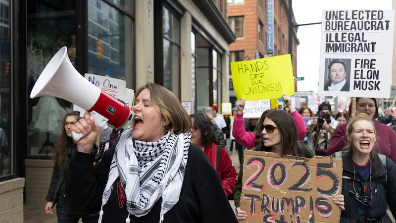 FILE - Community organizer Emerson Wolfe leads a march hosted by Indivisible Greater Grand Rapids down Ottawa Avenue during a Hands Off! rally, April 5, 2025, in Grand Rapids, Mich. (Arthur H. Trickett-Wile/The Grand Rapids Press via AP)