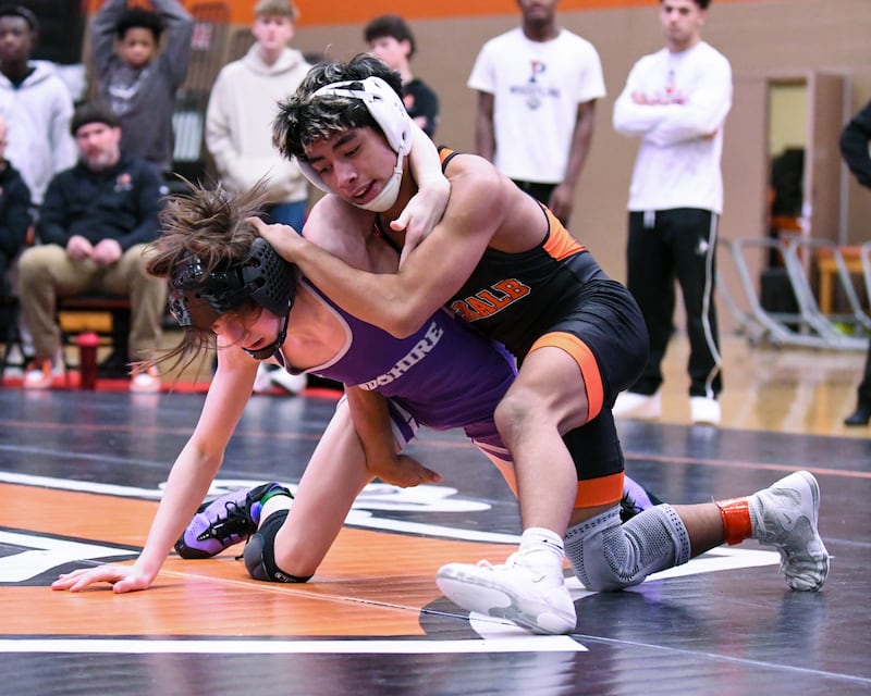 Julian Hartwig of DeKalb, right, wrestles Luthor Rajcevich of Hampshire during the 106-weight class during first-place regional match on Saturday Jan. 31, 2026, held at DeKalb High School.