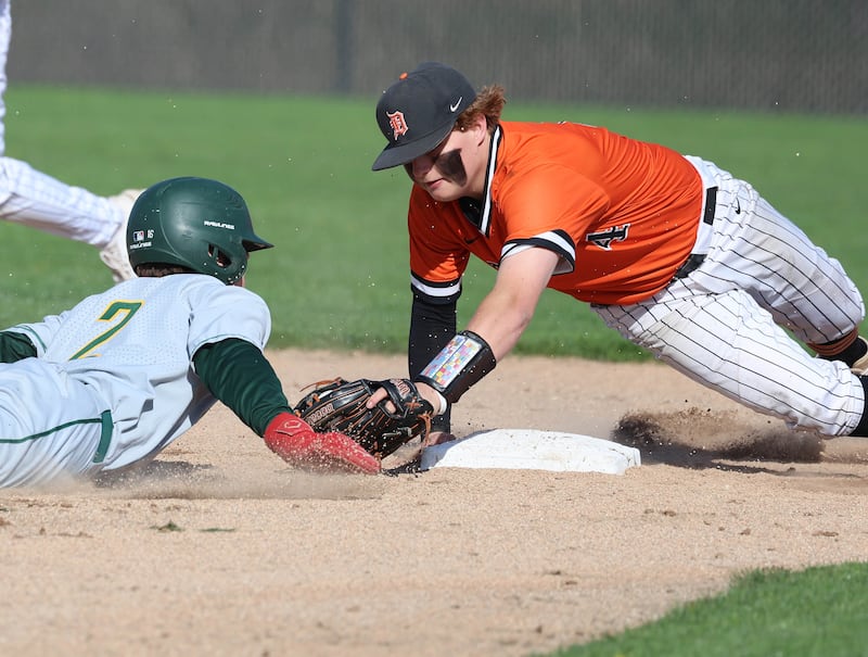DeKalb's Breydon Martin tags out Waubonsie Valley's Parker Howland trying to get back to second base Monday, April 20, 2026, during their game at DeKalb High School.