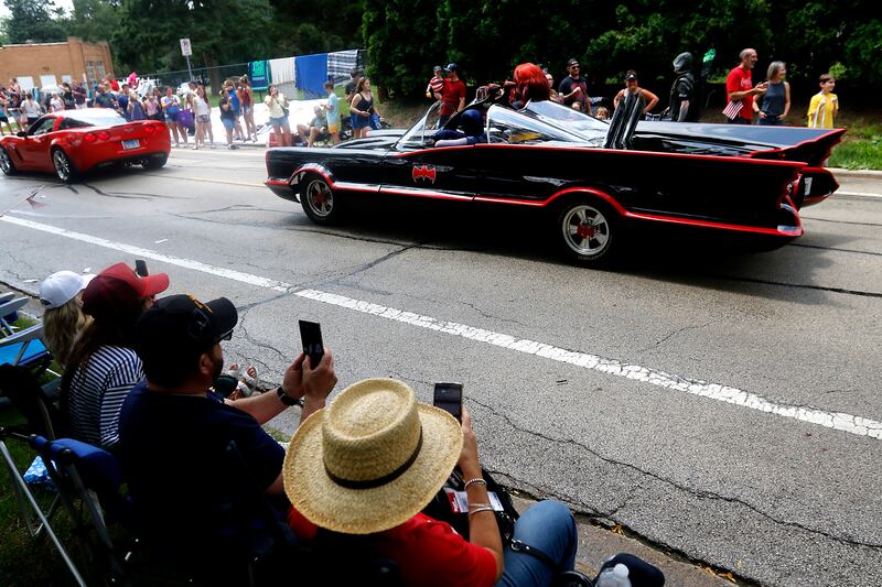 People photograph the Batmoblie from the Volo Musuem, on Sunday, July 7, 2024, during Crystal Lake’s annual Independence Day Parade on Dole Avenue in Crystal Lake. This year’s parade feature close to 100 units.