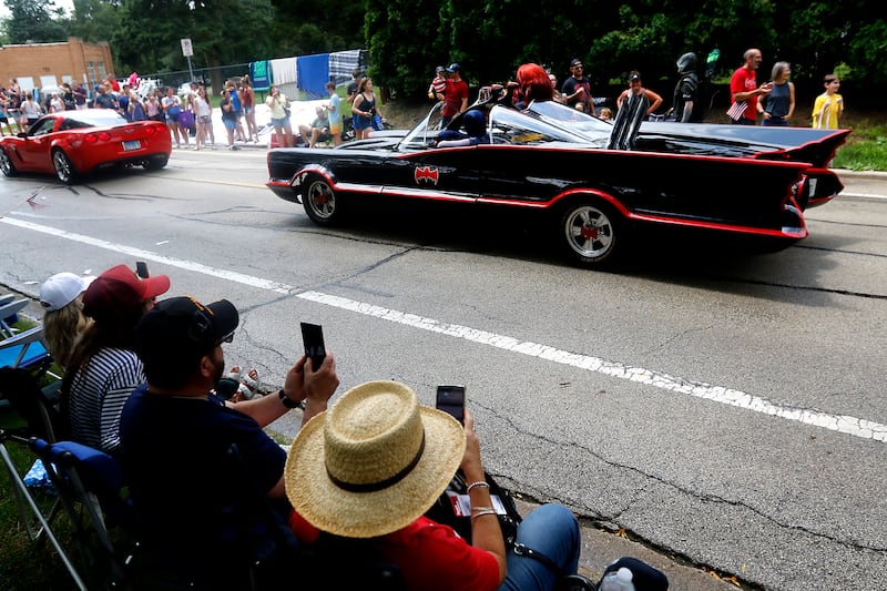 People photograph the Batmoblie from the Volo Musuem, on Sunday, July 7, 2024, during Crystal Lake’s annual Independence Day Parade on Dole Avenue in Crystal Lake. This year’s parade feature close to 100 units.