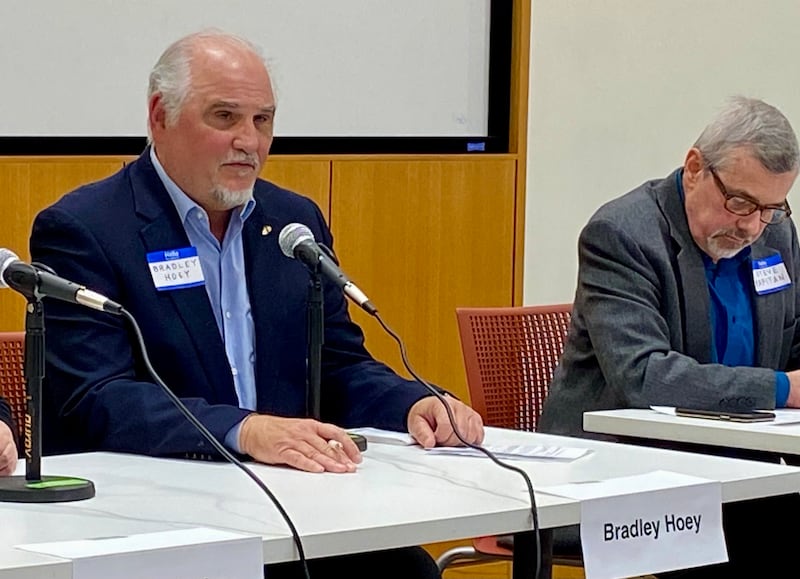 Bradley Hoey (left), retired Northern Illinois University communications professional, speaks at a candidate forum for the DeKalb City Clerk's race as opponent Steve Kapitan listens on Sunday, March 9, 2025, at the DeKalb Public Library, 309 Oak St. Hoey and Kapitan are running as write-in candidates for the clerk's office in the April 1, 2025, election.