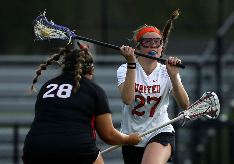 Crystal Lake Central co-op's Anna Starr passes the ball as she is defended by Huntley's Payton Turk during a Fox Valley Conference girls lacrosse match on Friday, April 17, 2026, at Crystal Lake Central High School.