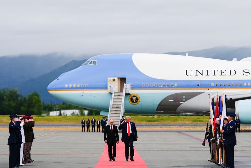 President Donald Trump salutes as he walks Russia's President Vladimir Putin, Friday, Aug. 15, 2025, at Joint Base Elmendorf-Richardson, Alaska. (AP Photo/Julia Demaree Nikhinson)